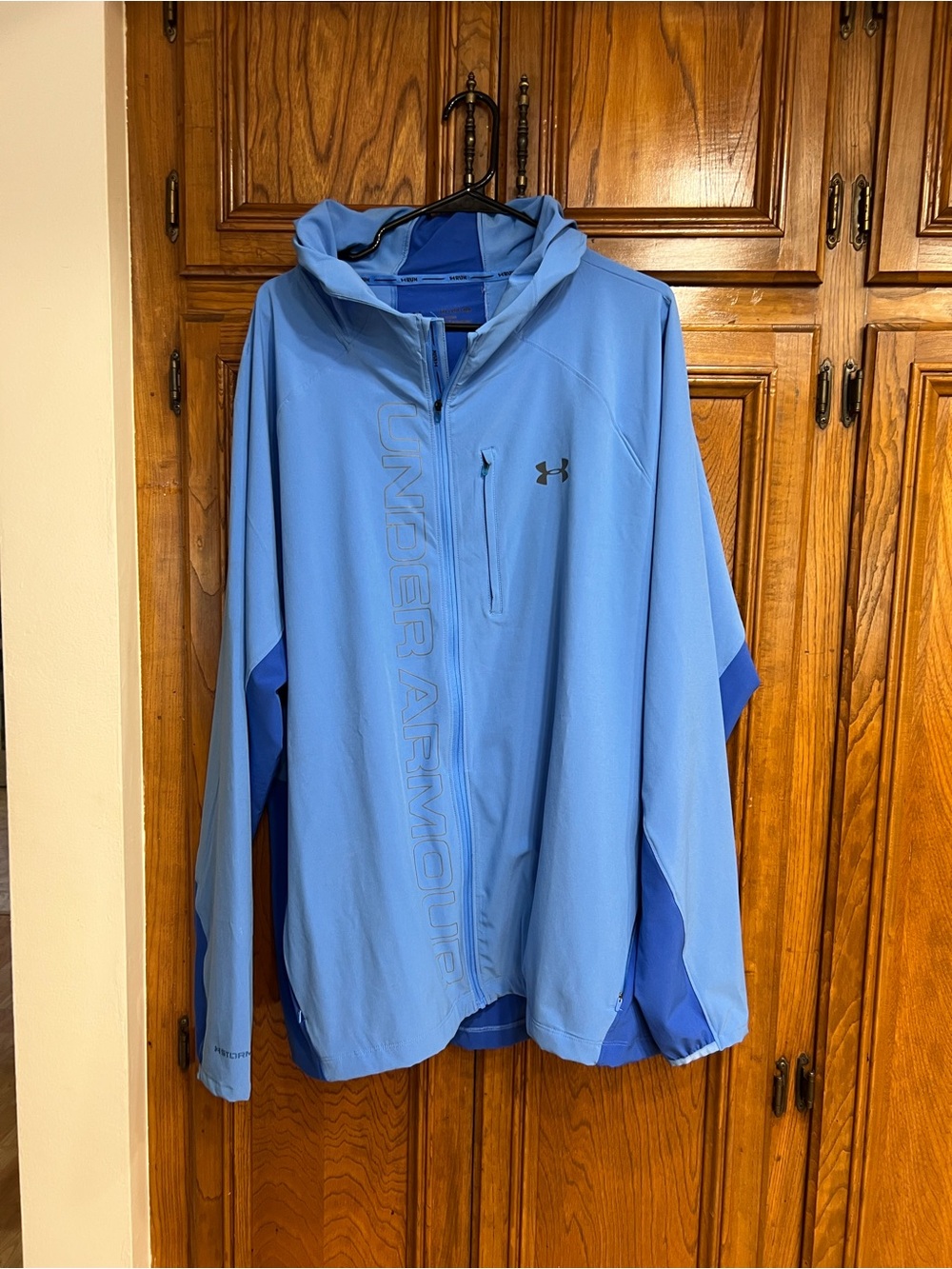 Under Armour Sky Blue  water repellent Hooded Windbreaker with Navy Accents.